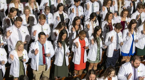  Graduates stand at HCOM white coat ceremony 2023 