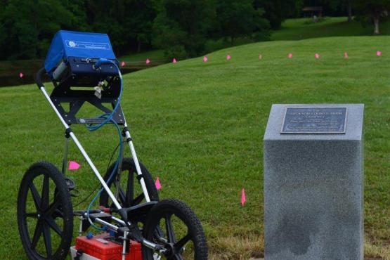  The Ground Penetrating Radar system pictured next to a memorial statue commemorating the Jackson County Cemetery. 