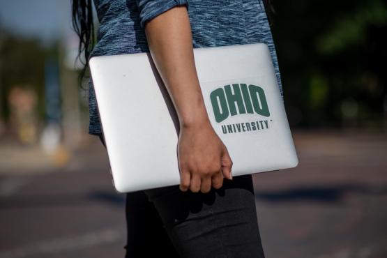 An OHIO student holds a laptop computer 