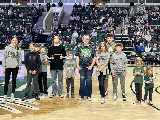 Participants of the Cat Camp diabetes day camp are shown posing for a photo on the basketball court at an OHIO Men&amp;#039;s Basketball game 