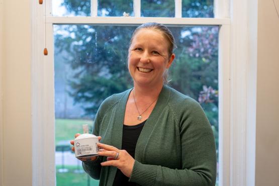 Natalie Kruse is shown holding  one of the air quality sensors