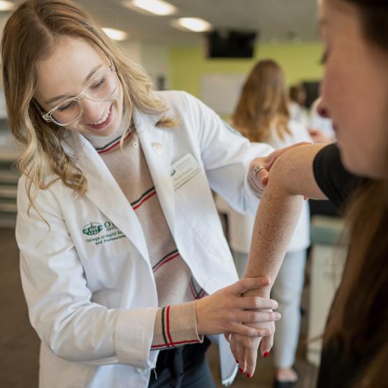 An OHIO medical student works with a patient