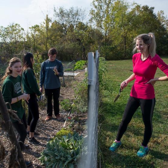 OHIO students are shown working in a garden