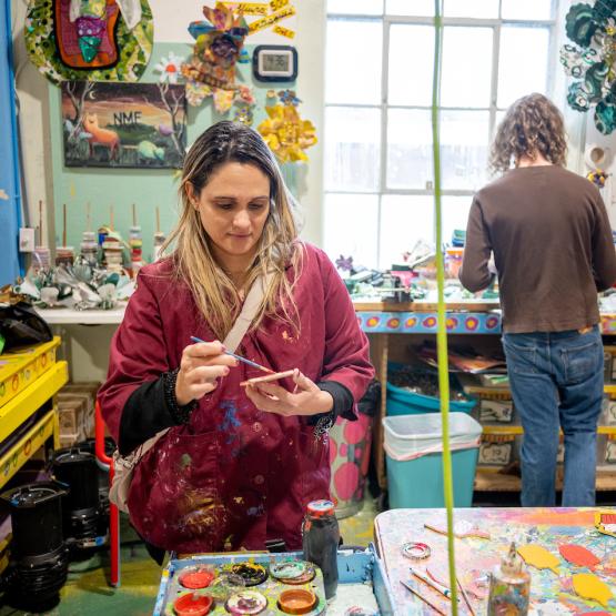 An OHIO student is shown working on an art project at the Passion Works studio