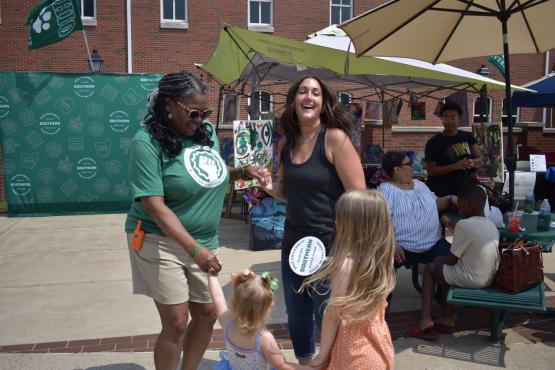  two women and a child dancing 