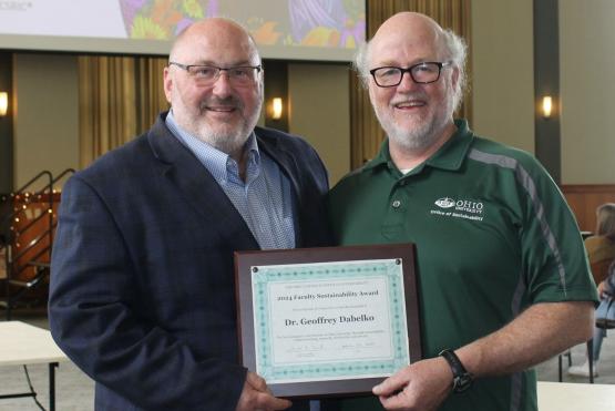  Geoff Dabelko and Sam Crowl hold the Faculty Sustainability Award that as presented to Dabelko 