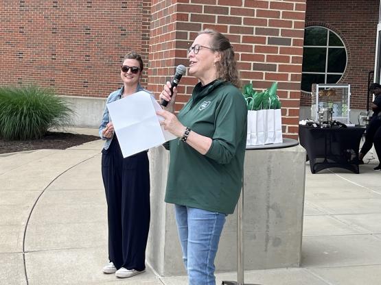 Lyn Redington is shown  speaking at the Student Affairs event celebrating the end of the academic year