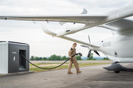  An individual hooks up charging equipment to an airplane 