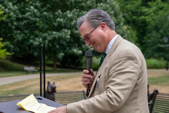 Michael Wells speaks during the dedication ceremony