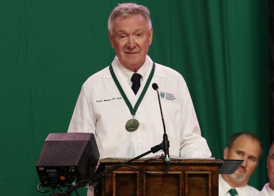 Ronald Moomaw, D.O. (’80), NASA retired physician and a member of the college’s first class, speaks at convocation