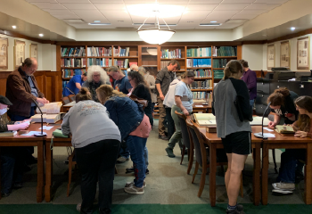 Members of the OHIO community look over displays in the Mahn Center for Archives and Special Collections