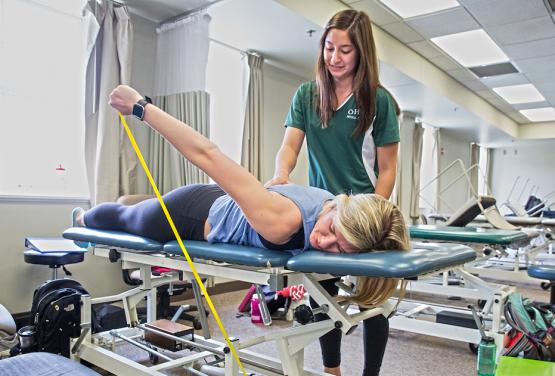  A physical therapy student at Ohio University works to rehabilitate a patient&#039;s injury 