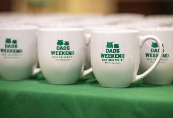 A photo of coffee mugs that all say "Dads Weekend - Ohio University"