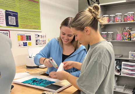 Bridget Burkett and Andie Miller working on their project in the CoLab Makerspace