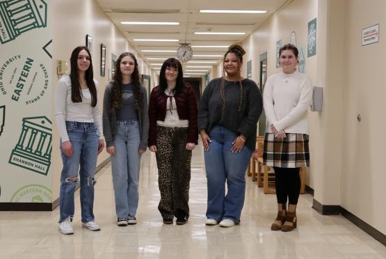  5 female students standing side by side 