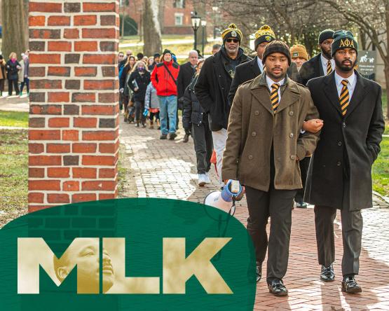  OHIO students and community members are shown taking part in the Silent March, and the letters MLK are in front of part of the image 