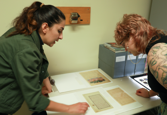  Two individuals look over part of the Founders Day exhibit 