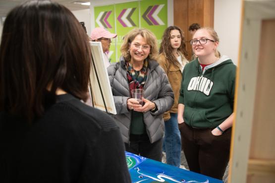An OHIO student is shown with her mother at the Pop Up Market in Alden Library during Moms Weekend 2024.