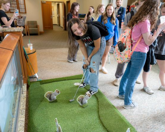 An OHIO student plays miniature golf at a Giving Day event