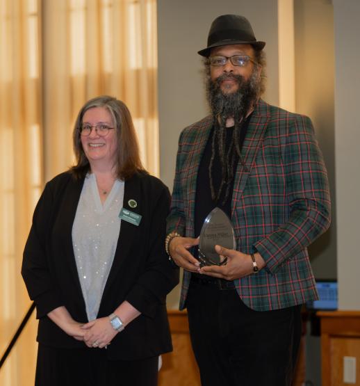 Katie Hartman and Uzoma Miller are shown with Miller's award