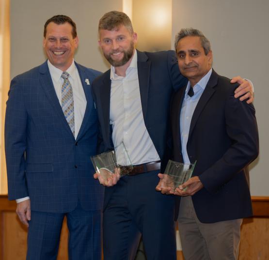Eric Muth, Dustin Grooms and Vishwajeet Puri are shown at the awards ceremony