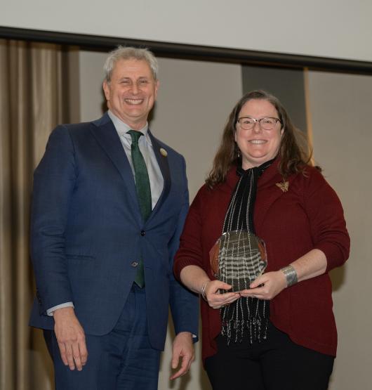 Provost Don Leo and Sabrina Curran are shown with Curran's award