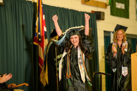  An OHIO graduate raises her arms in triumph as she crosses the stage the OHIO Lancaster Graduation Recognition Ceremony 