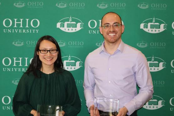 Victoria Lee and Brett Peters are shown holding their awards