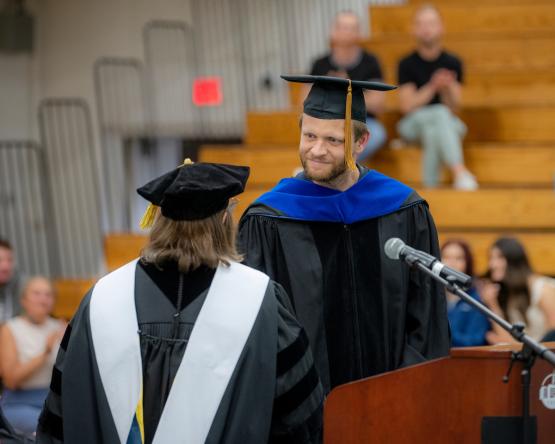 Dr. Roberta Milliken congratulates Dr. Michael Koop