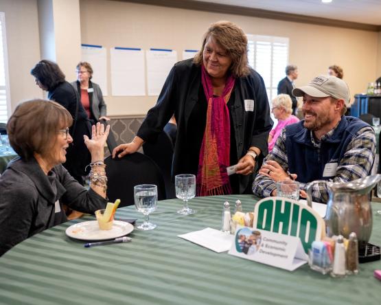 OHIO community members speak together while gathered around a table at the Community Engagement Symposium 