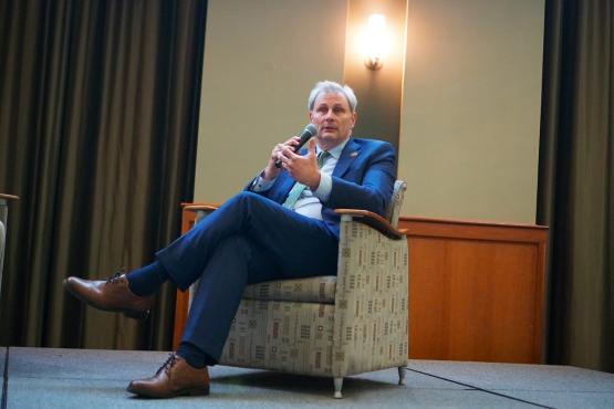 Executive Vice President and Provost Donald Leo speaks to the crowd while sitting in a chair on the stage at the LEAD Live event