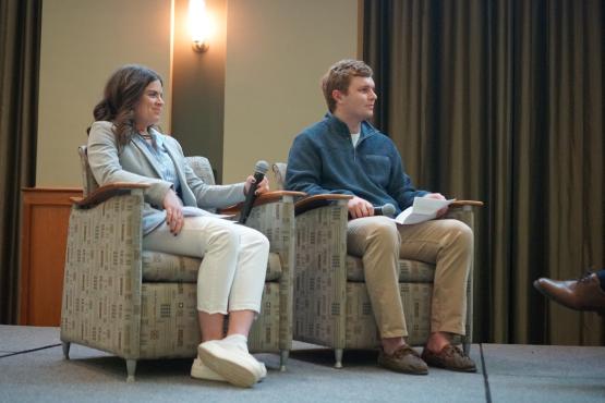Lily Branch and Ryan Koenig sit in chairs on the stage at the LEAD Live event