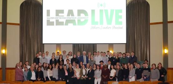  OHIO students, faculty and staff stand in front of the LEAD Live graphic in the Walter Rotunda 