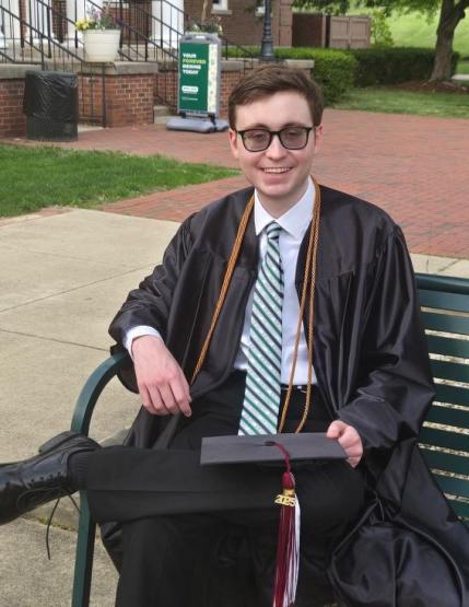  Seth Southers sits in front of Bennett Hall 