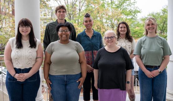  English graduate students and mentors pose for a picture outside Ellis Hall 
