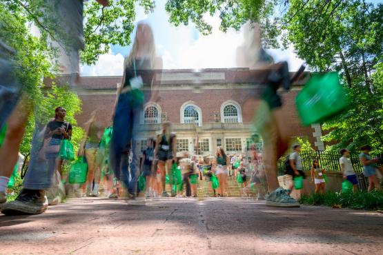  Blurred images of students in motion crossing College Green 