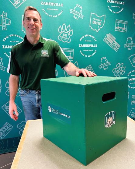 Charles Marsden with box for area school athletics