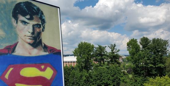  An artistic image of Superman is shown against the Athens skyline, which includes the Convocation Center 