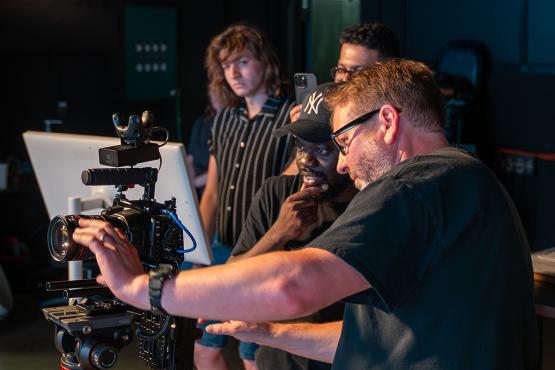  Instructor and students look at a camera attached to the Scripps College of Communication&amp;amp;#039;s new LED video wall 