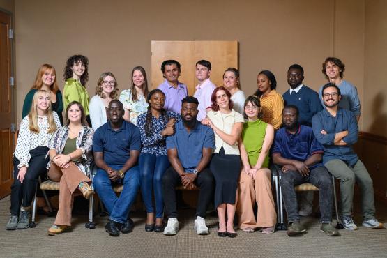 Students studying Environmental Studies sit and stand together for a group photo