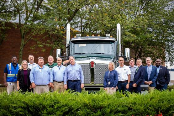  Representatives of  and Kenworth stand in front of a truck outside of the Chillicothe plant 