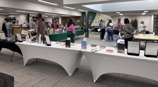 People look at the tables of books at the Banned Book Cafe event at Ohio University Zanesville in 2024