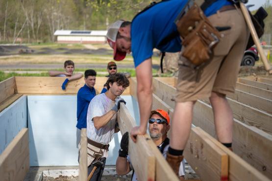 Volunteers from Ƶ work on framing a house