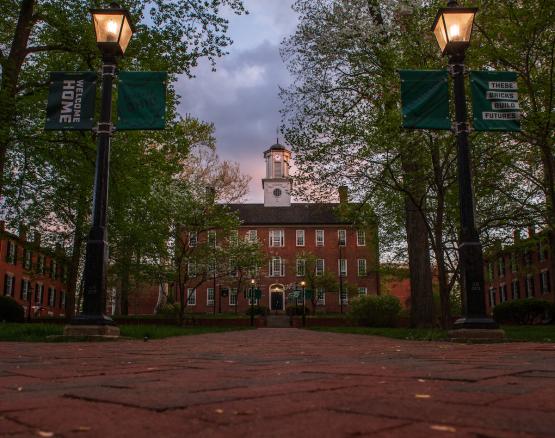 Cutler Hall and the College Green are shown in the evening