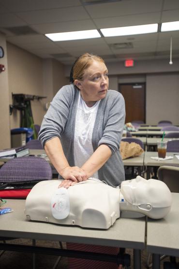  woman performs cpr on dummy 