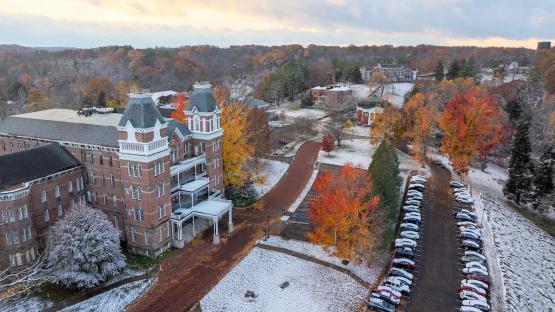 The buildings and colorful fall trees at the Ridges are covered with a thin layer of snow