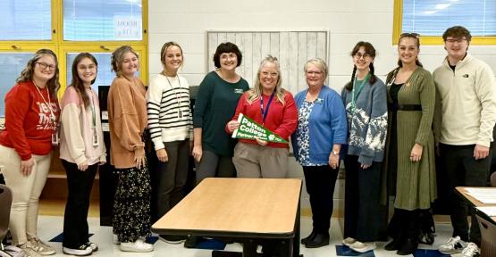  OHIO Zanesville and Zane Grey Elementary School representatives stand together for a photo inside of an elementary school classroom 