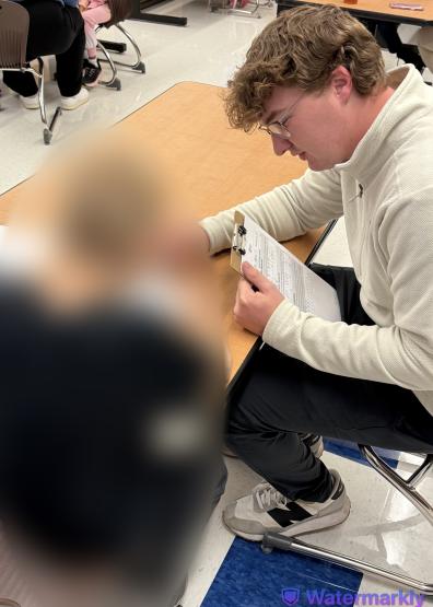An OHIO Zanesville student works on a project while sitting at a table at Zane Grey Elementary School