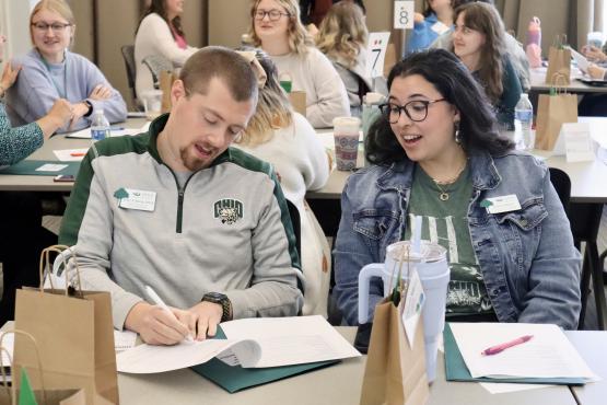  Two students discussing and writing during group activity 