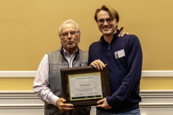 John Kopchick and Thomas Krauss hold the award